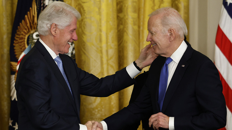 Bill Clinton embracing Joe Biden