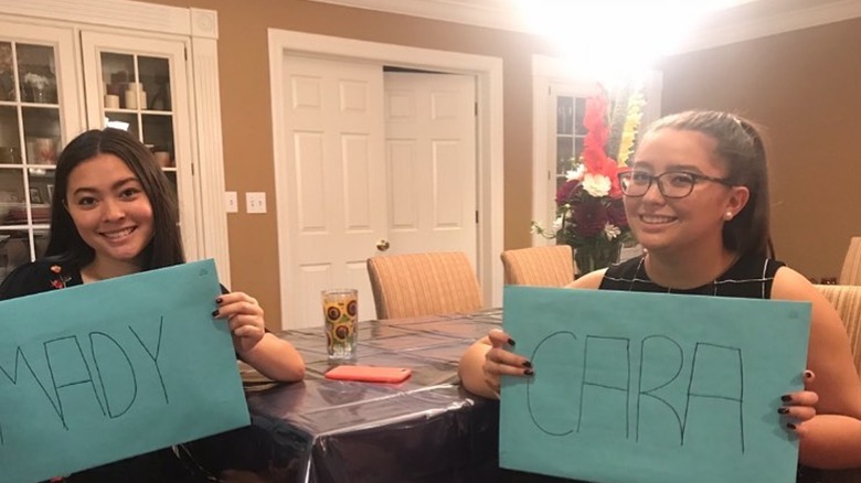 Mady and Cara Nicole Gosselin holding signs