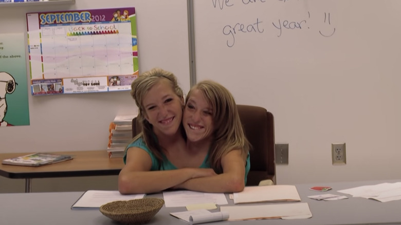 Brittany and Abby Hensel smiling in classroom