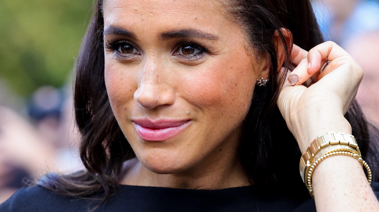 Meghan Markle holding hair