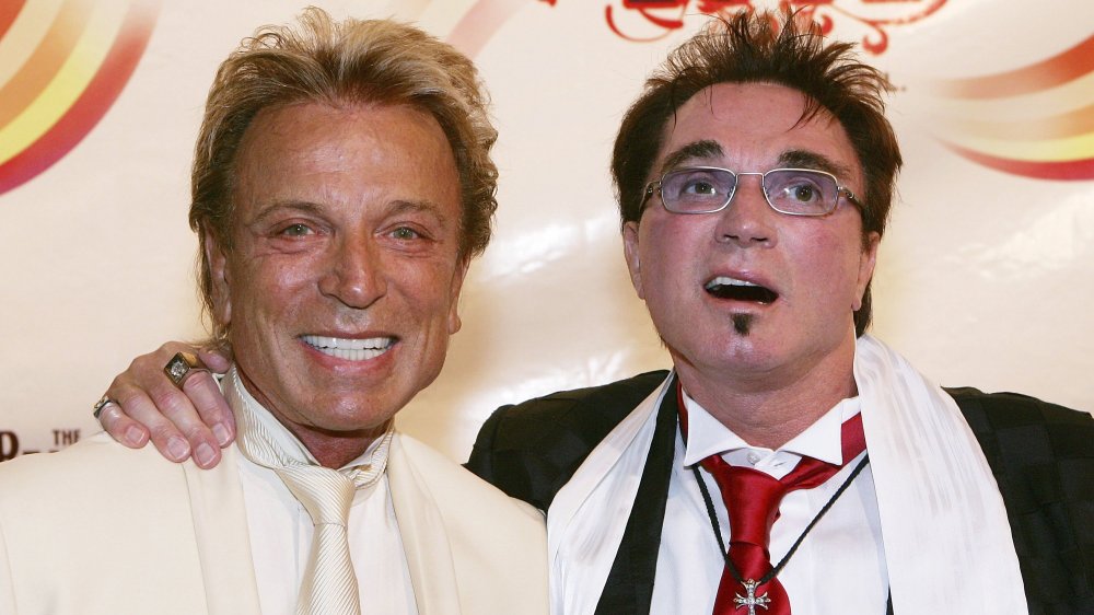 Roy Horn (R), of the illusionist duo Siegfried & Roy hugs musician Ringo Starr after attending the gala premiere of "The Beatles LOVE by Cirque du Soleil"