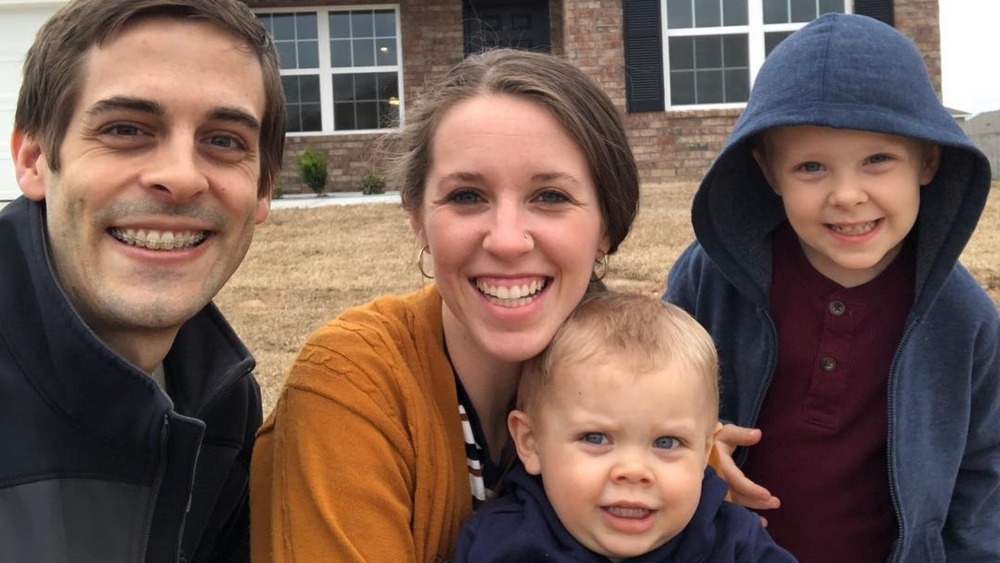 Derick Dillard and Jill Duggar with kids at house