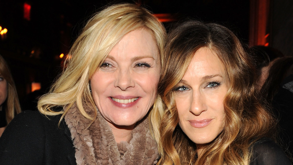 Kim Cattrall and Sarah Jessica Parker posing cheek to cheek 