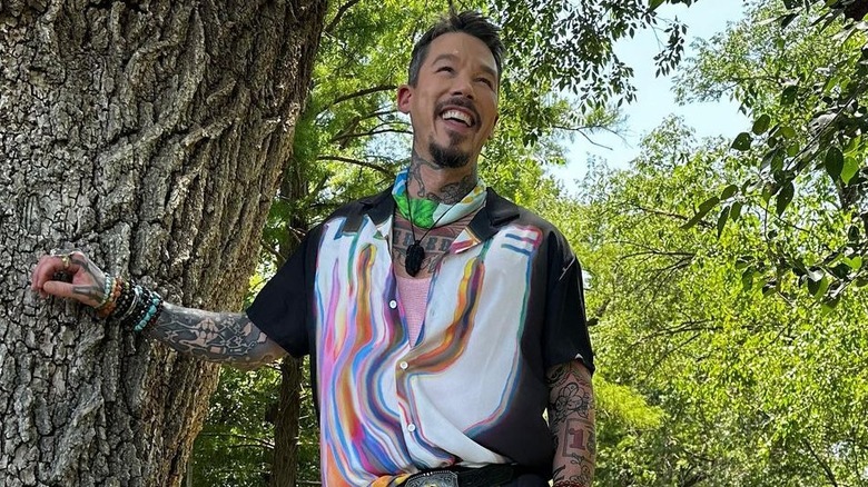 David Bromstad laughing next to a tree