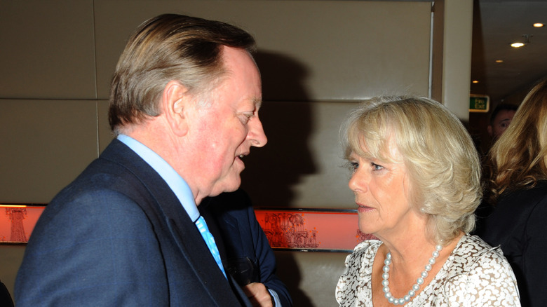 Andrew Parker Bowles and Queen Camilla stand together speaking