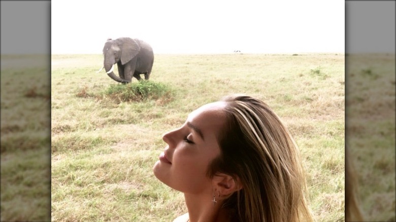 Candice Swanepoel poses with an elephant