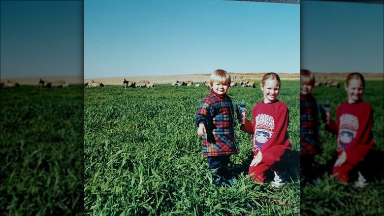 Young Candice Swanepoel with cousin on a farm