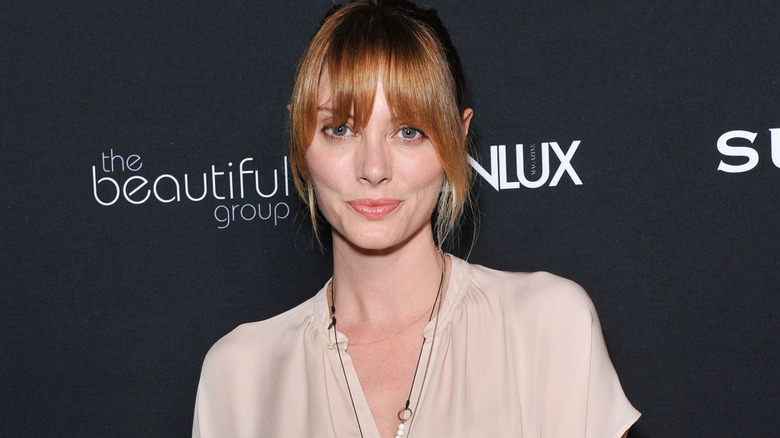 April Bowlby posing in a cream colored top