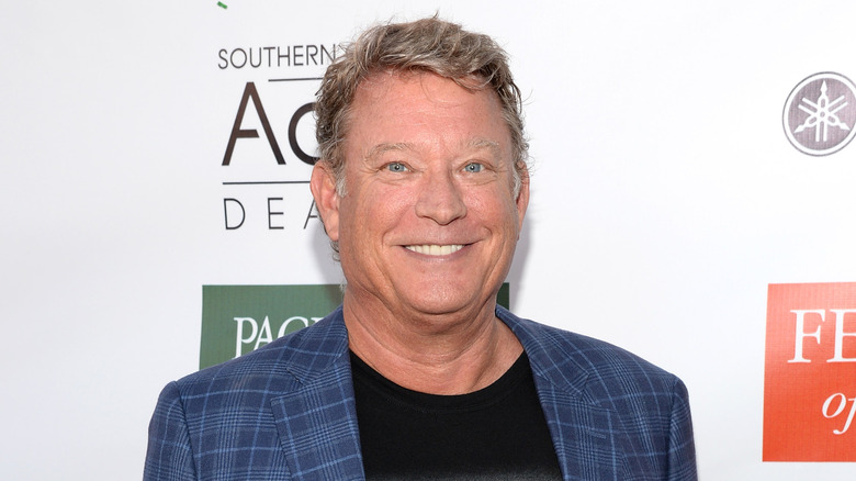 Christopher Rich smiling in close-up wearing blue plaid jacket