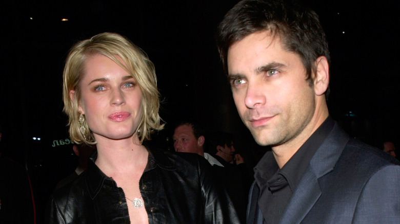 Rebecca Romijn and John Stamos pose 