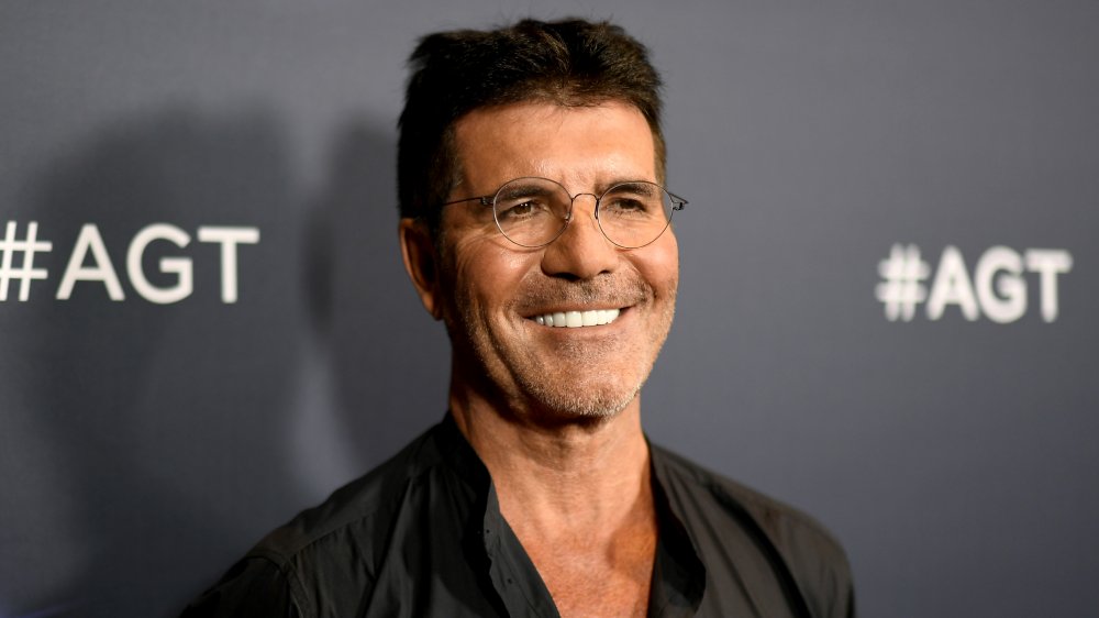 Simon Cowell with round glasses