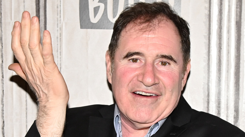 Richard Kind with hand up in air