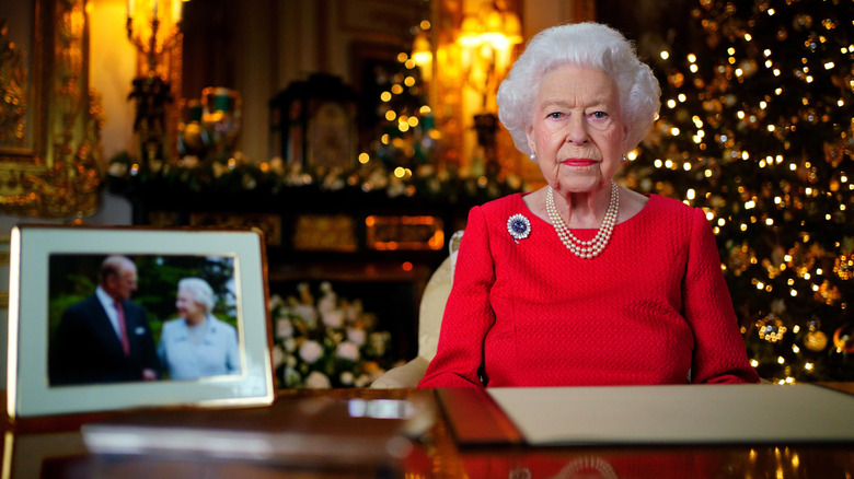 Queen Elizabeth II sitting at desk