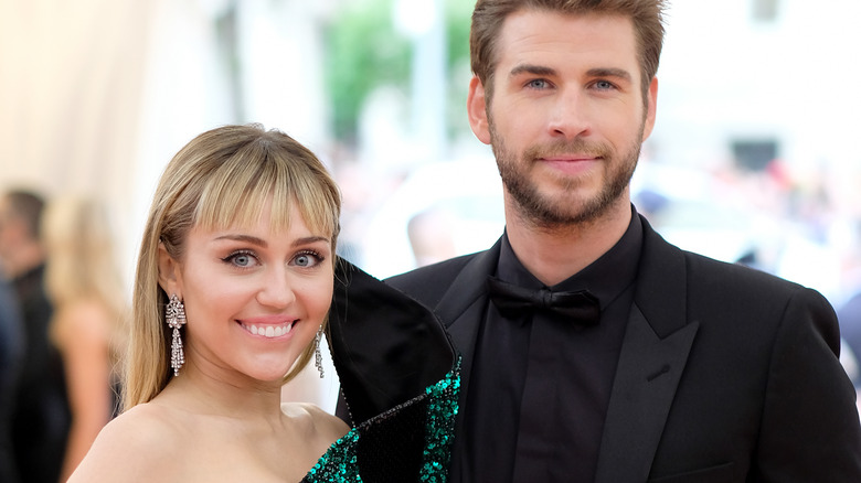 Miley Cyrus and Liam Hemsworth posing