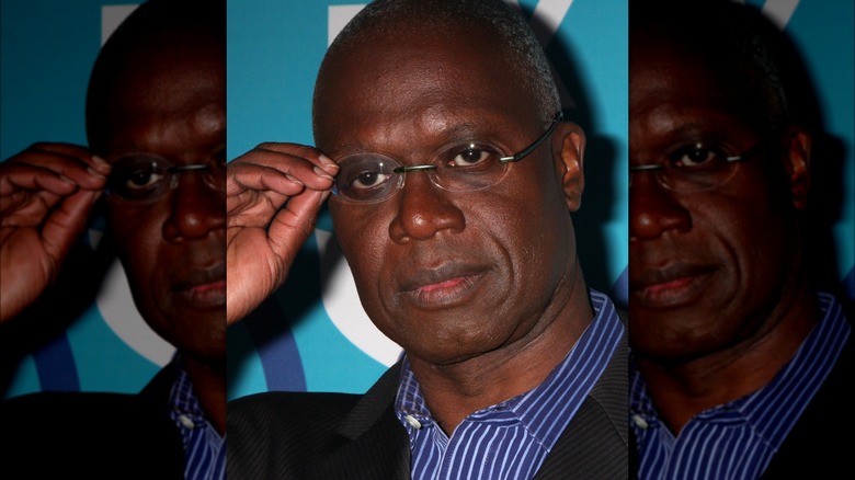 Andre Braugher touching glasses