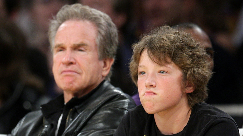 Warren and Benjamin Beatty sitting courtside at a game