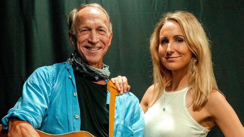 Nikki Glaser with hand on dad's shoulder