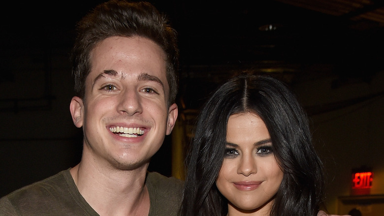 Charlie Puth with arm around Selena Gomez