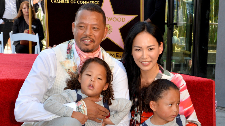 Terrence Howard posing with his youngest children and wife Mira Pak Howard