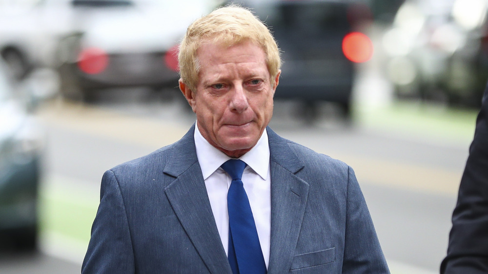 Robert Flaxman wearing a suit while leaving the courthouse