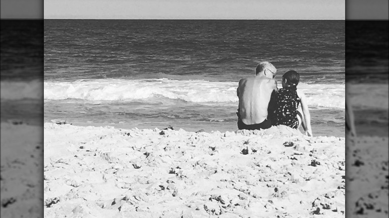 Anthony Bourdain and Ariane sitting on the beach