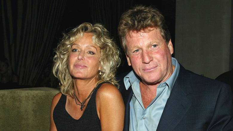 Farrah Fawcett and Ryan O'Neal at a table in 2003