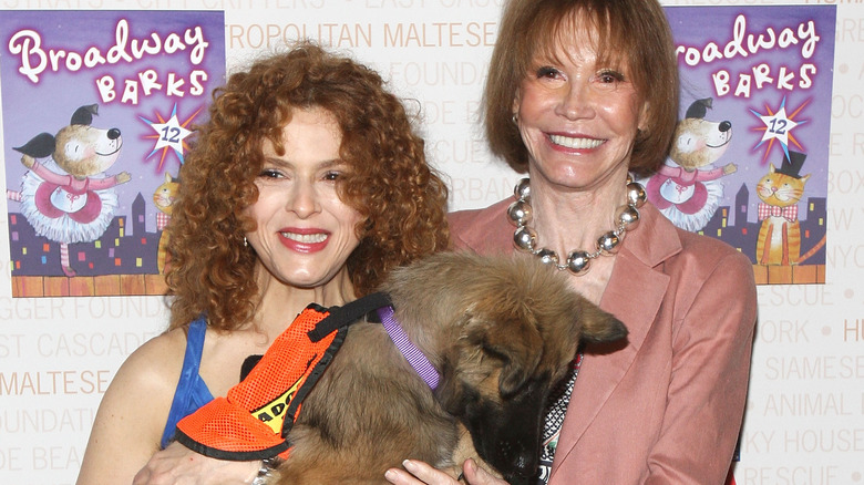 Bernadette Peters and Mary Tyler Moore holding a dog