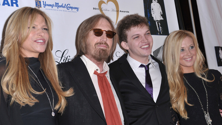 Tom Petty posing with his wife and children