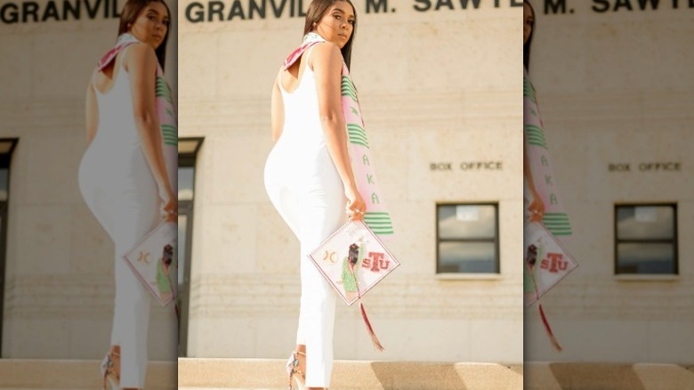 Kelsey Riley posing with her graduation cap