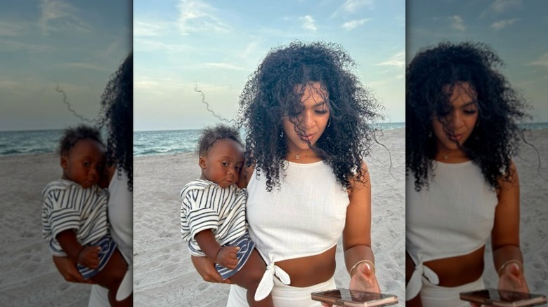 Kelsey Riley holding her son on the beach