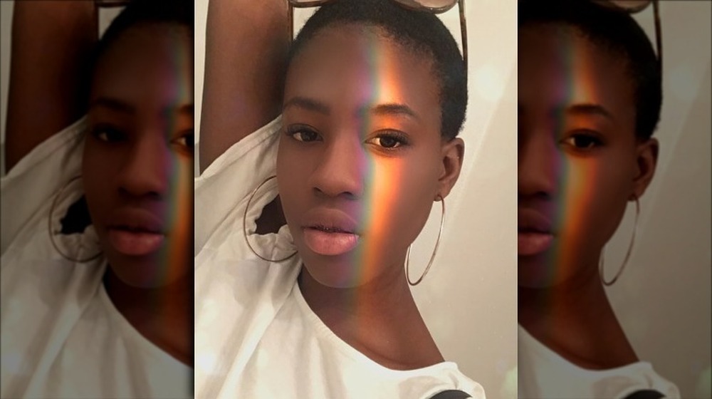 Gabrielle Gorman poses for a selfie on Instagram with rainbow light on her face