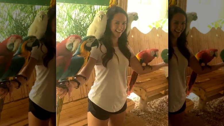 Jordon Hudson posing with parrots