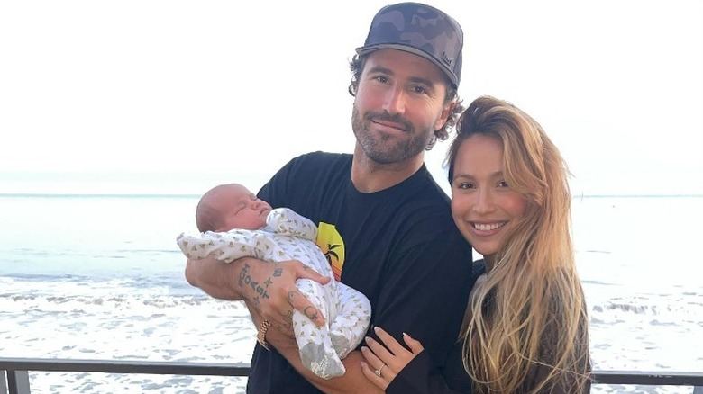 Brody Jenner and Tia Blanco posing with their baby