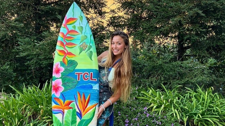 Tia Blanco posing with surf board