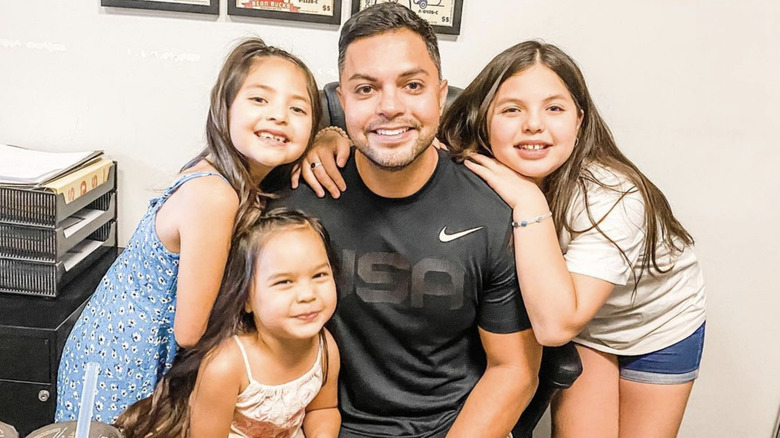 Danna Bui-Negrete's husband and daughters smiling