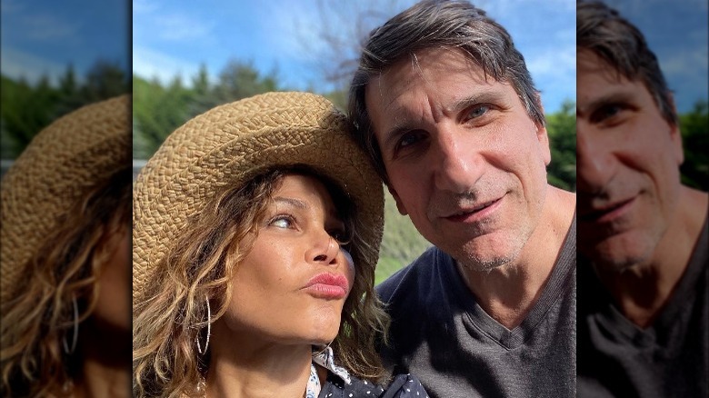 Daphne Rubin-Vega, looking at husband Tommy Costanzo, making the kissy face, wearing a hat, Memorial Day 2020, Tommy Costanzo smiling, looking at camera