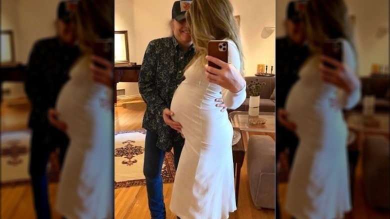 Dwight Yoakam and Emily Joyce posing with baby bump