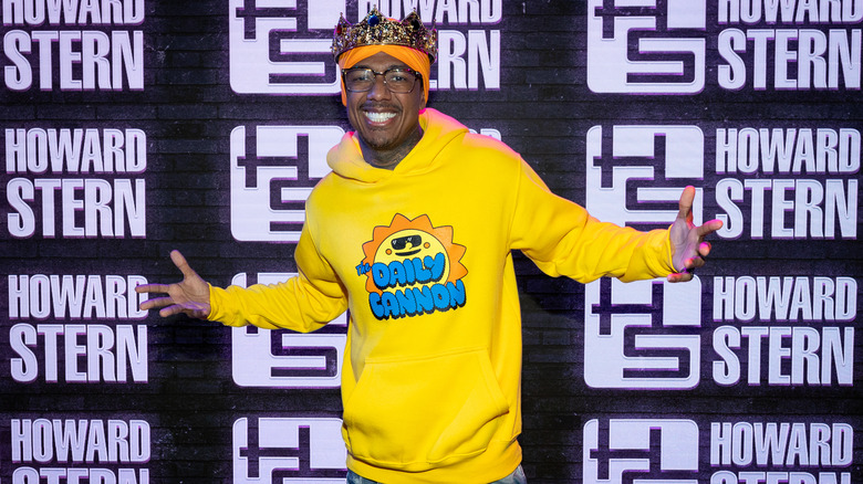 Nick Cannon in a yellow hoodie and a crown