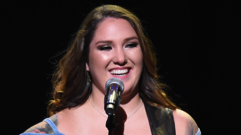 Allie Colleen Brooks singing into microphone