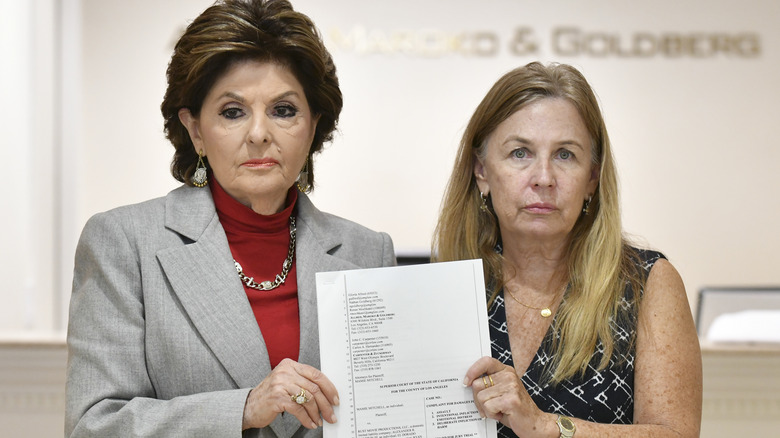 Gloria Allred with Mamie Mitchell holding documents