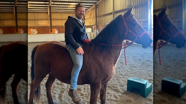 Cory Miller poses on a horse 