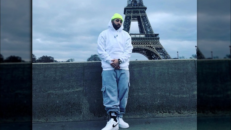 Jay Worthy posing in front of the Eiffel Tower