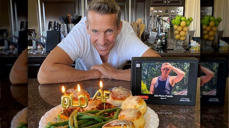 Chris Heisser posing with cake