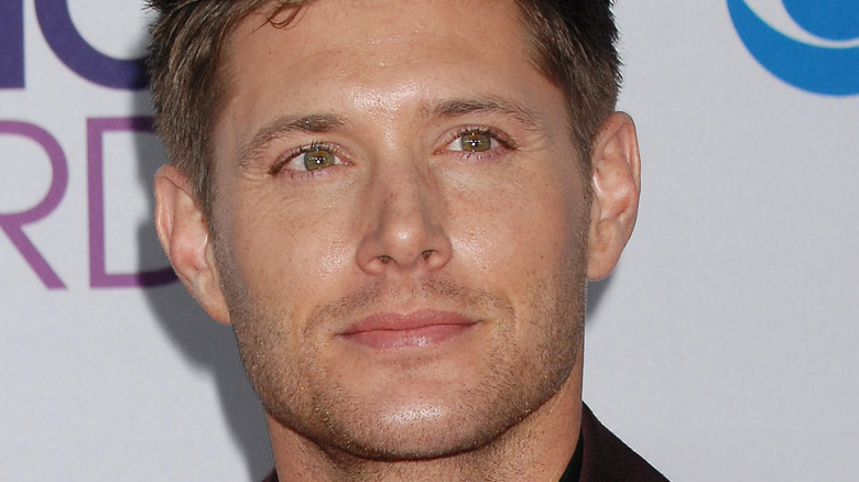 Jensen Ackles poses at an event
