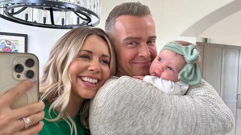 Samantha Cope smiling with Joey Lawrence and baby