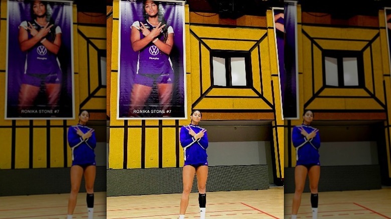 Ronika Stone posing in front of poster of herself