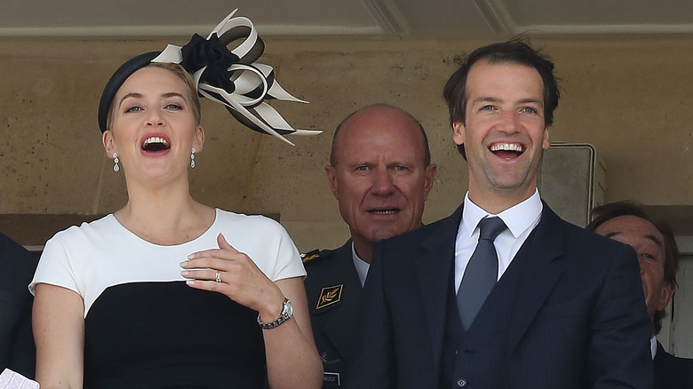 Kate Winslet and Edward Abel Smith react from a balcony