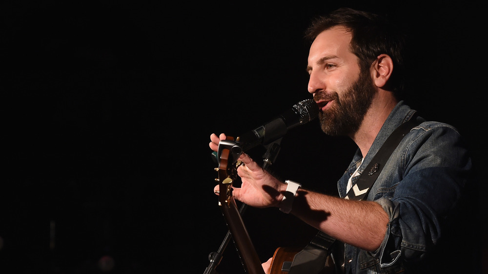 Josh Kelley performing on-stage with a guitar