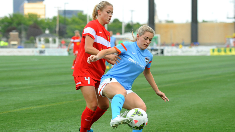 Kealia Ohai getting tackled soccer