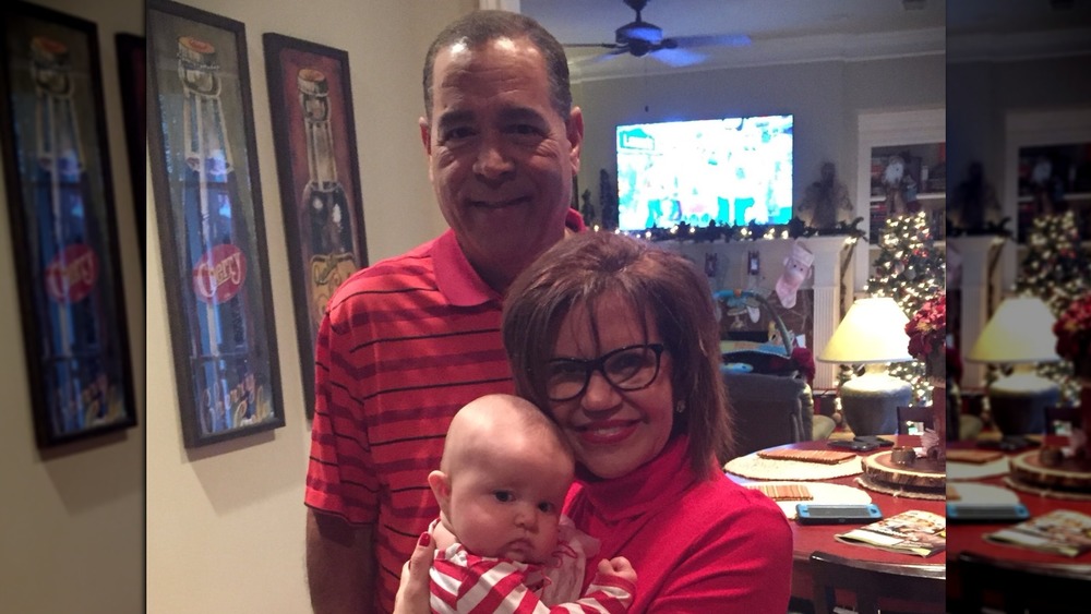 Kelvin Sampson and his wife Karen Sampson with their grandchild in a Twitter photo